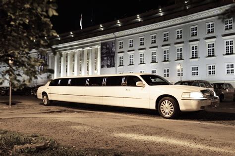 biała limuzyna zaparkowana przed kościołem, z czerwonym dywanem rozłożonym przed wejściem