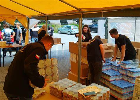 zdjęcie wolontariuszy rozdających paczki żywnościowe potrzebującym