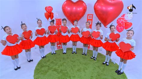Maturzystki w białych sukniach i ze świecącymi skrzydłami wykonujące taniec podczas studniówki w Radzyniu Podlaskim.