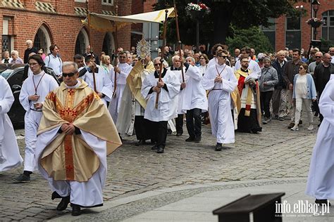 Zdjęcie przedstawiające barwną procesję Bożego Ciała z ołtarzami i wiernymi.