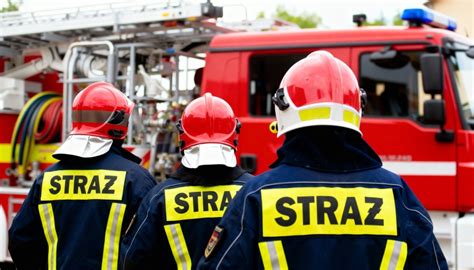 Strażacy w akcji podczas tradycyjnego śmigusa-dyngusa, przygotowani z sikawkami wodnymi.