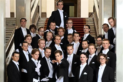 Grupa debiutantów w eleganckich strojach na balu